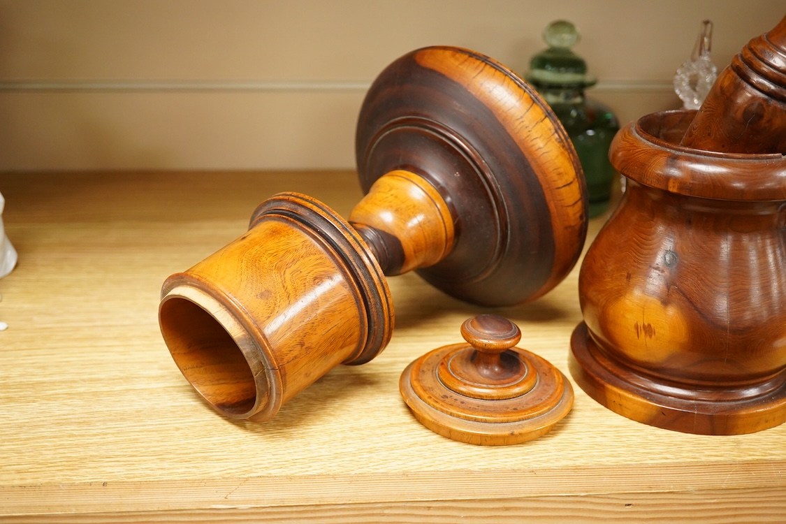 A 19th century treen lignum vitae pestle and mortar and turned cup and cover on stand- 25cm high